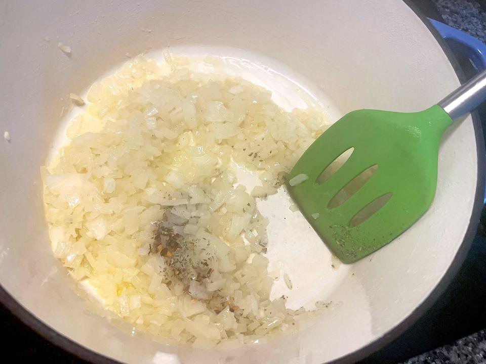 Adding herbs to onions for Ina Garten's Penne Alla Vodka