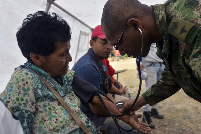 A Colombian medic attends wounded people at a shelter in Mocoa, Putumayo department, southern Colombia on April 3, 2017