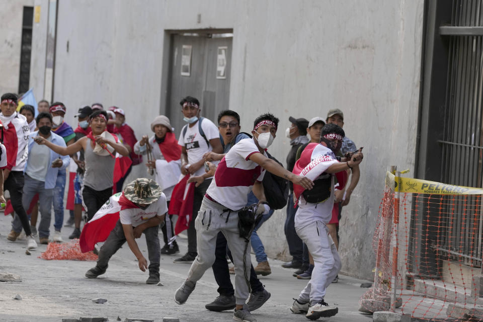 Anti-government protesters who traveled to the capital from across the country to march against Peruvian President Dina Boluarte, clash with the police in Lima, Peru, Thursday, Jan. 19, 2023. Protesters are seeking immediate elections, Boluarte's resignation, the release of ousted President Pedro Castillo and justice for the dozens of protesters killed in clashes with police. (AP Photo/Martin Mejia)