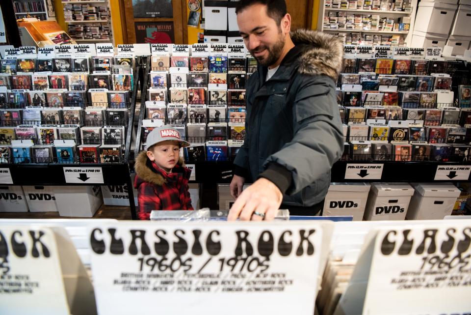 Matt Peroni, right, of Hamilton, New Jersey, shops for records with his son, Carmine, 4, at Siren Records on Small Business Saturday in Doylestown Borough on Saturday, November 27, 2021.