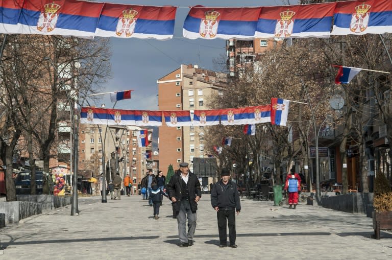 Kosovo Serbs walk in the north of the divided town where there is little integration between them and the far larger ethnic Albanian community living south of the Ibar river