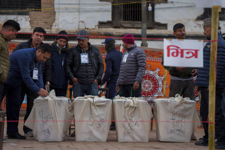 Election commission staff seal ballot boxes after completion of polling during the general election in Kathmandu, Nepal, Sunday, Nov. 20, 2022. Voters in Nepal lined up Sunday to elect members of Parliament in hopes that a new government would bring political stability and help with the Himalayan nation's development. (AP Photo/Niranjan Shrestha)