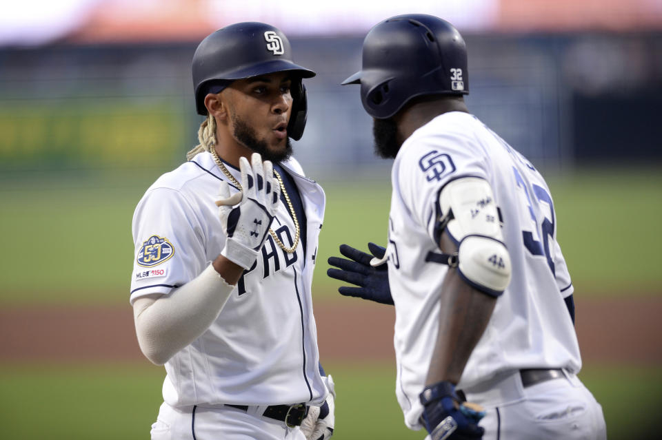 San Diego Padres' Fernando Tatis Jr., left, is congratulated by Franmil Reyes after hitting a home run during the first inning of a baseball game against the Baltimore Orioles, Monday, July 29, 2019, in San Diego. (AP Photo/Orlando Ramirez)