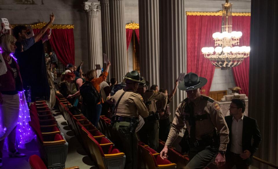 People are escorted out of the House gallery at Tennessee state Capitol in Nashville , Tenn., Monday, April 3, 2023.