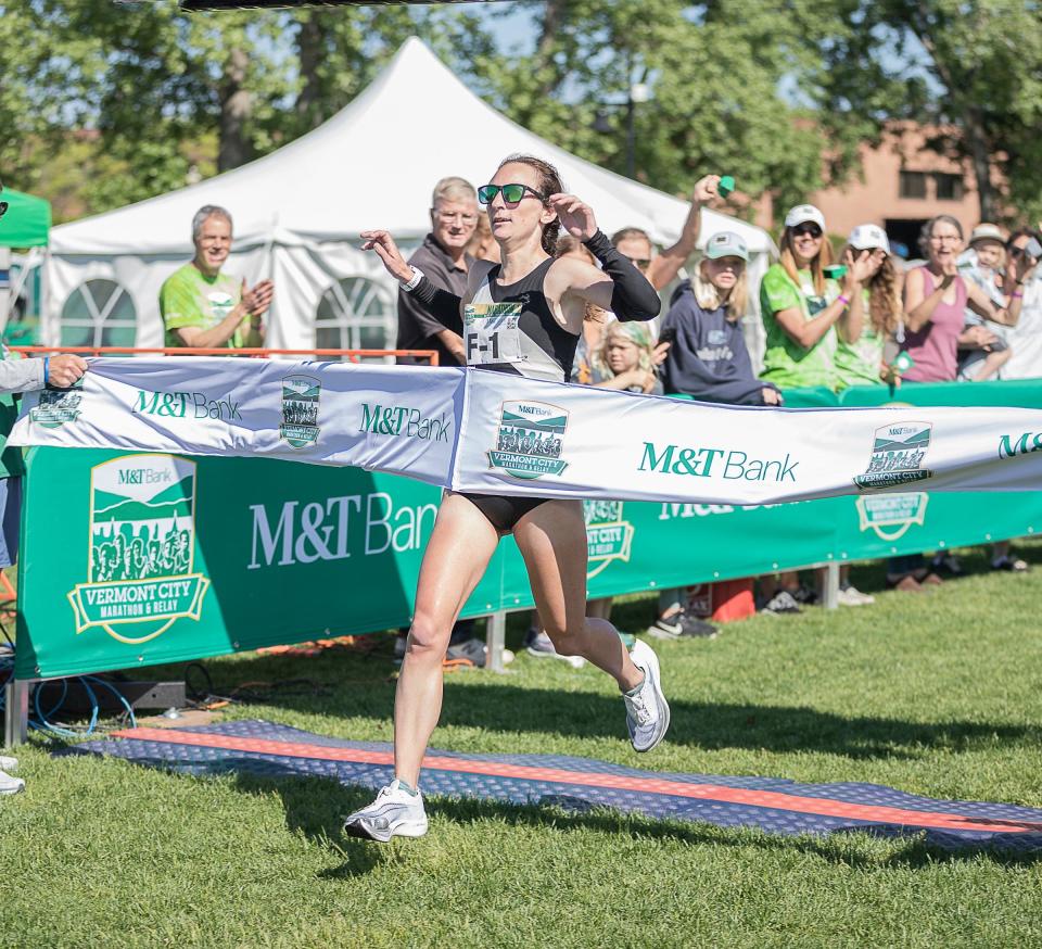 Annmarie Tuxbury crosses the finish line as the first female runner of the M & T Bank Vermont City Marathon on Sunday May 29, 2022.