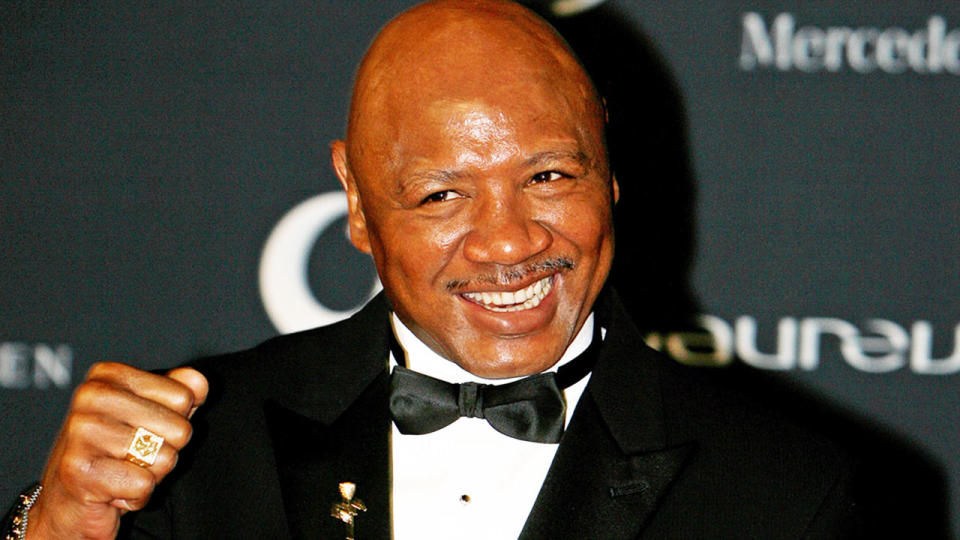 Boxing Hall of Famer Marvin Hagler is seen here posing for a photo at an event.