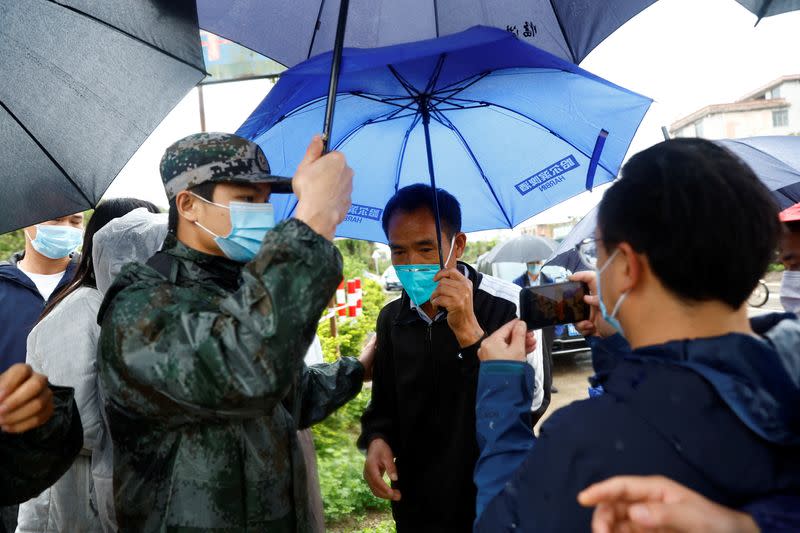 A man surnamed Ding, relative of a victim, arrives at the entrance of Lu village near the site where a China Eastern Airlines Boeing 737-800 plane flying from Kunming to Guangzhou crashed, in Wuzhou