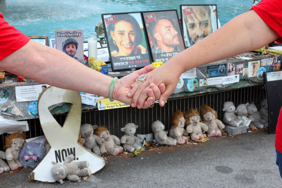 People hold hands at a memorial event marking the one-year anniversary of the Hamas attack in southern Israel, in Tel Aviv, Oct. 7, 2024. / Credit: JACK GUEZ/AFP/Getty