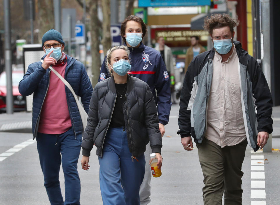 People are seen wearing masks in Bourke street in Melbourne, Sunday, July 19, 2020.