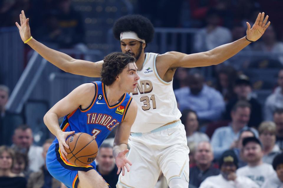 Oklahoma City Thunder guard Josh Giddey (3) drives against Cleveland Cavaliers center Jarrett Allen (31) during the first half of an NBA basketball game, Saturday, Dec. 10, 2022, in Cleveland. (AP Photo/Ron Schwane)