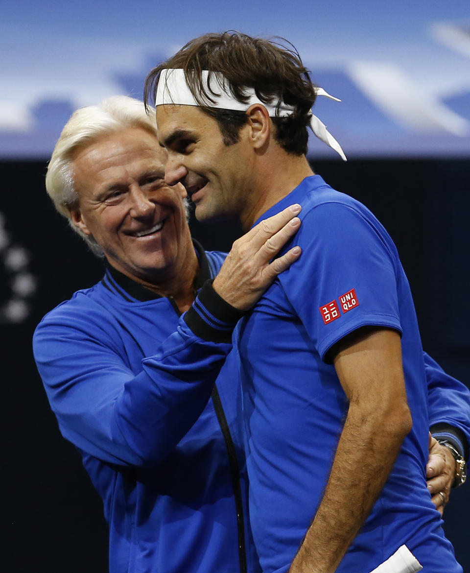 Team Europe's Roger Federer, right, and Bjorn Borg celebrate a men's singles tennis match win against Team World's John Isner at the Laver Cup, Sunday, Sept. 23, 2018, in Chicago. (AP Photo/Jim Young)