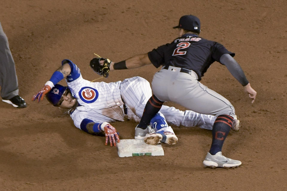 Chicago Cubs' Javier Baez (9) is tagged out by Cleveland Indians second baseman Yu Chang (2) during the second inning of a baseball game Wednesday, Sept. 16, 2020, in Chicago. Baez had singled, and tried to advance to second after the throw went to third. (AP Photo/Mark Black)