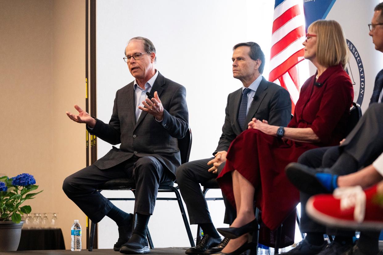 Sen. Mike Braun, left, addresses the audience during the National Federation of Independent Businesses gubernatorial candidate forum and luncheon on Tuesday, March 19, 2024, at the Wellington Fishers Banquet & Conference Center in Fishers, Indiana.