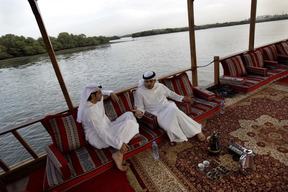In this Wednesday, April 4, 2012 photo, Mohamed al-Suwaidi, left, and Abdulla al-Suwaidi, Vice Chairman & M.D. of RAK Pearls Holding are seen during a tour on the Ras al-Khaimah lagoon, United Arab Emirates. Long before the discovery of oil transformed the Gulf, the region's pearl divers were a mainstay of the economy. Their way of life, however, also was changed forever after Japanese researchers learned how to grow cultured pearls in 1930s. Now a collaboration between pearl traders in Japan and the United Arab Emirates had brought oyster farming to the UAE for the first time. (AP Photo/Kamran Jebreili)