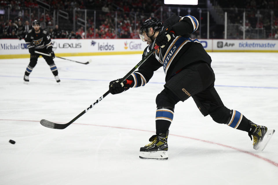 Washington Capitals left wing Alex Ovechkin (8) shoots the puck during the first period of an NHL hockey game against the Arizona Coyotes, Saturday, Nov. 5, 2022, in Washington. (AP Photo/Nick Wass)