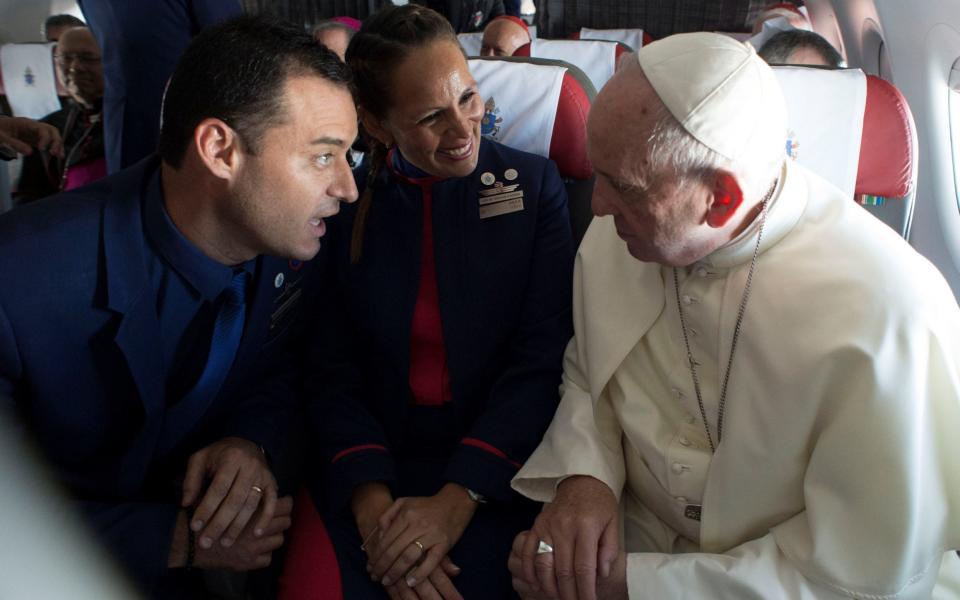 Pope Francis with crew members Paula Podest and Carlos Ciuffardi during the flight between Santiago and the northern city of Iquique, Chile January 18, 2018. - REUTERS