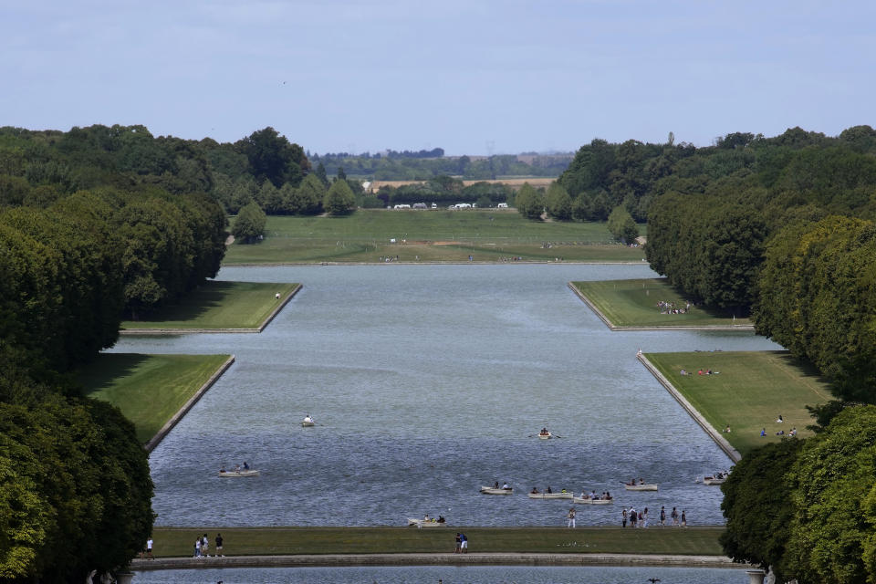 People row on the canal of the park at the Chateau de Versailles, that will host the equestrian events at the Paris 2024 Olympic Games, in Versailles, west of Paris, Saturday, July 15, 2023. (AP Photo/Christophe Ena)