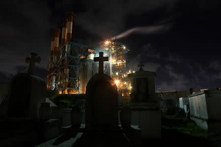 Central Palo Seco power station of the Puerto Rico Electric Power Authority (PREPA) is seen behind a cemetery, in San Juan, Puerto Rico January 22, 2018. REUTERS/Alvin Baez