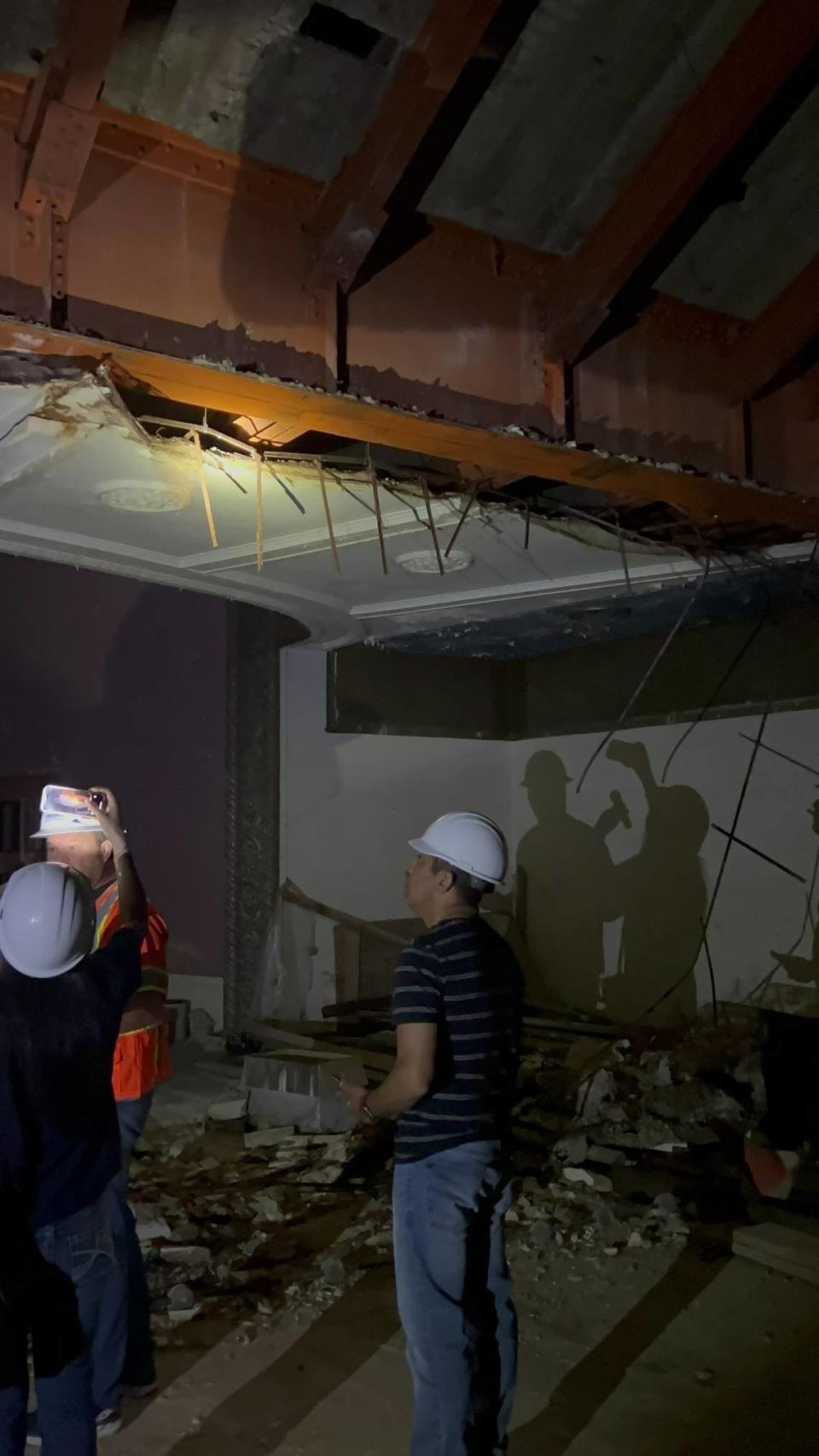 Fresno City Councilmember Miguel Arias and other officials observe a damaged plaster ceiling inside Hardy’s Theater during a city inspection of the historically listed building April 28, 2023.