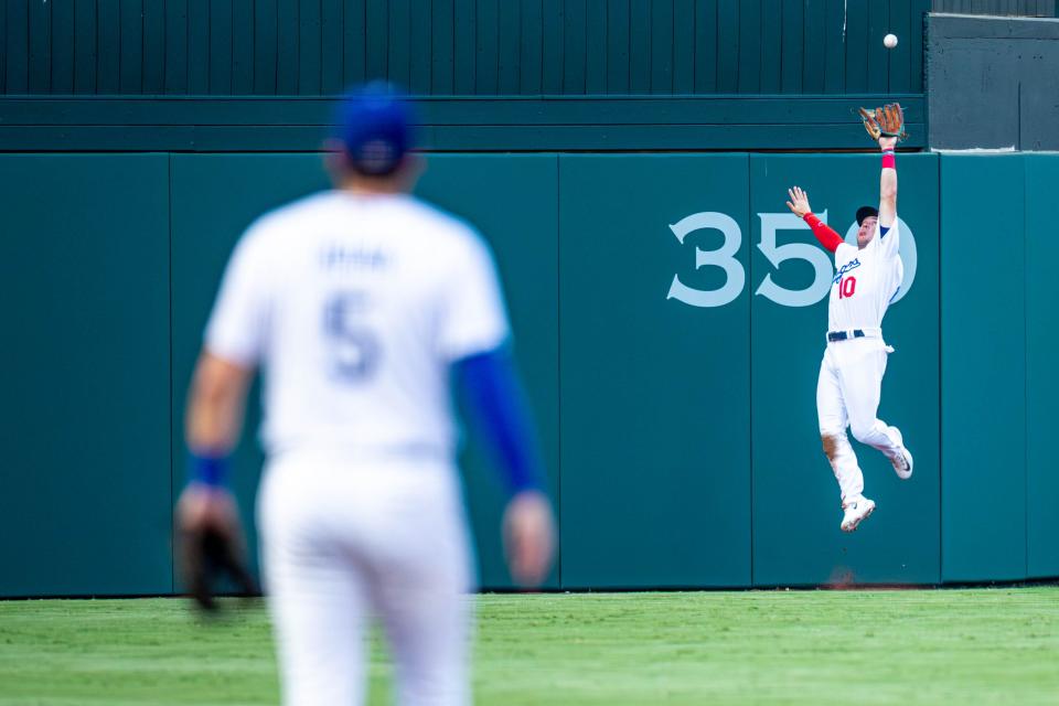 Oklahoma City Dodgers outfielder Ryan Ward (10) jumps up to catch a ball headed over the fence June 21 during a game between the Oklahoma City Dodgers and the Las Vegas Aviators at Chickasaw Bricktown Ballpark in Oklahoma City.