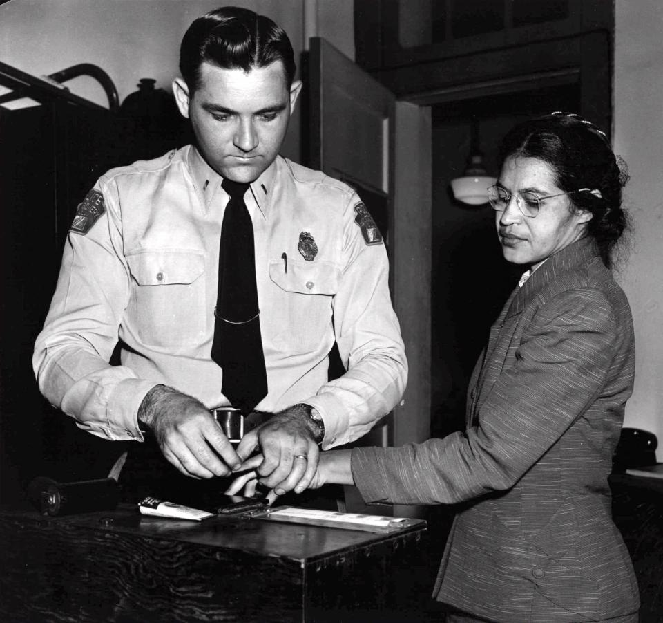 FILE--Rosa Parks, whose refusal to move to the back of a bus touched off the Montgomery bus boycott and the beginning of the civil rights movement, is fingerprinted by Deputy Sheriff D.H. Lackey in Montgomery, Ala., Feb. 22, 1956. Parks was among some 100 people charged with violating segregation laws. (AP Photo/Gene Herrick)