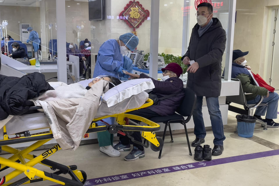 Elderly patients are checked as they arrive at an emergency hall of a hospital in Beijing, Thursday, Jan. 19, 2023. China on Thursday accused "some Western media" of bias, smears and political manipulation in their coverage of China's abrupt ending of its strict "zero-COVID" policy, as it issued a vigorous defense of actions taken to prepare for the change of strategy. (AP Photo/Andy Wong)