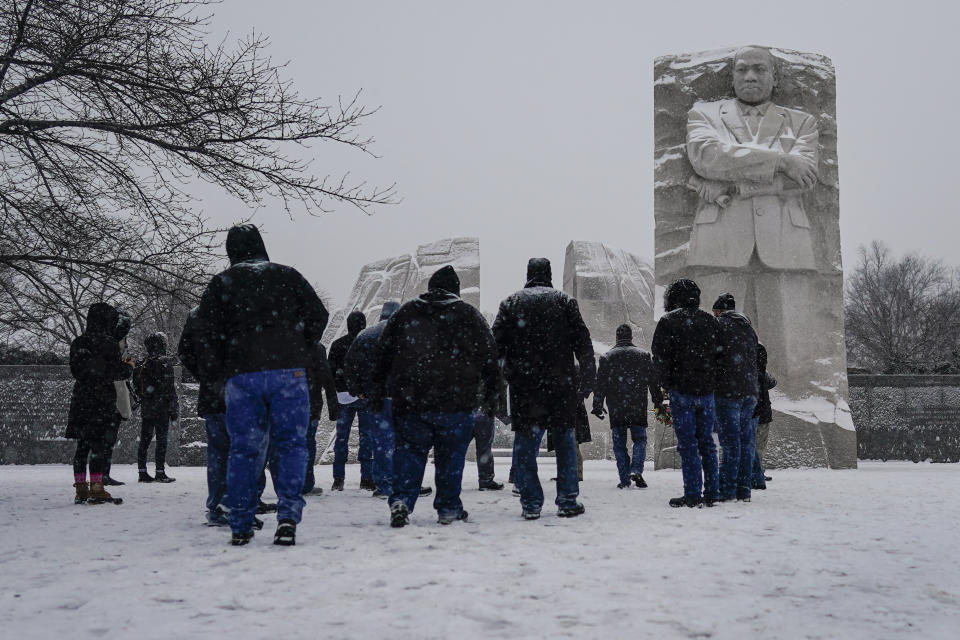 Visitors gather at the Martin Luther King Jr. Memorial as snow falls in Washington, D.C., on Sunday. Ceremonies scheduled for the site on Monday, to mark the Martin Luther King Jr. national holiday, were canceled because of the weather. (Carolyn Kaster/AP)<br><figcaption>Law enforcement officials gather at a local school near the Congregation Beth Israel synagogue on Saturday in Colleyville, Texas, where a gunman held four hostages. The 10-hour-long standoff ended after the hostages escaped and the gunman was shot to death. The FBI was investigating the incident as a "terrorism-related matter." (Gareth Patterson/AP) </figcaption><figure><figcaption>Linsey Jones, a medical assistant working at a drive-up COVID-19 testing clinic, wears an N95 mask in Puyallup, Washington, south of Seattle. The Biden administration launched a website for Americans to place orders for the 400 million N95 masks the federal government is offering free to Americans . The Centers for Disease Control and Prevention says N95 and KN95 masks better protect against the omicron variant of COVID-19 than cloth face coverings. (Ted S. Warren, File/AP)</figcaption></figure><figure><figcaption>In this image from Senate Television, Sen. <span class="caas-xray-inline-tooltip"><span class="caas-xray-inline caas-xray-entity caas-xray-pill rapid-nonanchor-lt" data-entity-id="Joe_Manchin" data-ylk="cid:Joe_Manchin;pos:1;elmt:wiki;sec:pill-inline-entity;elm:pill-inline-text;itc:1;cat:OfficeHolder;" tabindex="0" aria-haspopup="dialog"><a href="https://search.yahoo.com/search?p=Joe%20Manchin" data-i13n="cid:Joe_Manchin;pos:1;elmt:wiki;sec:pill-inline-entity;elm:pill-inline-text;itc:1;cat:OfficeHolder;" tabindex="-1" data-ylk="slk:Joe Manchin;cid:Joe_Manchin;pos:1;elmt:wiki;sec:pill-inline-entity;elm:pill-inline-text;itc:1;cat:OfficeHolder;" class="link ">Joe Manchin</a></span></span> (D-WV) speaks Wednesday on the floor of the U.S. Senate at the Capitol in Washington, D.C. Voting legislation that Democrats and civil rights leaders say is vital to protecting democracy collapsed when Manchin and Sen. Krysten Sinema (D-AZ) refused to join their own party in changing Senate rules to overcome a Republican filibuster after a raw, emotional debate. (Senate Television via AP)<br><br></figcaption><figure><figcaption>A member of the media picks up a shredded box at a section of the Union Pacific train tracks in downtown Los Angeles on Jan. 14. Thieves have been raiding cargo containers aboard trains nearing downtown Los Angeles for months, leaving the tracks blanketed with discarded packages. The sea of debris left behind included items that the thieves apparently didn't think were valuable enough to take, CBSLA reported Thursday. (Ringo H.W. Chiu/AP)</figcaption></figure></figure><figure><figcaption>A person wearing a face shield walks past the Olympic rings inside the main media center at the 2022 Winter Olympics Wednesday in Beijing. NBC will not send its announcers and most hosts to the Beijing Olympics due to continued concerns about rising COVID-19 cases worldwide and China's strict policy about those who test positive. (David J. Phillip/AP)<br></figcaption></figure><figure><figcaption>Penn swimmer Lia Thomas, a transgender athlete, competes in a 500-meter race in Philadelphia. The NCAA has adopted a sport-by-sport approach for transgender athletes, bringing the organization in line with the U.S. and International Olympic Committees. Thomas started smashing records this year. (Heather Khalfia/The Philadelphia Inquirer via AP)</figcaption></figure><figure><figcaption>Louie Anderson appears during the 2017 Winter Television Critics Association press tour in Pasadena, California, on Jan. 12, 2017. Anderson, whose four-decade career as a comedian and actor included his unlikely and Emmy-winning performance as mom to twin adult sons in the TV series “Baskets,” has died at age 68. (Richard Shotwell/Invision/AP, File)<br></figcaption><figure><figcaption> A jury of 18 people who appeared to be mostly white was picked Thursday for the federal trial of three Minneapolis police officers charged in George Floyd’s killing, a case that the judge told potential jurors has “absolutely nothing” to do with race. In this image from surveillance video, Minneapolis police officers (from left) Tou Thao, Derek Chauvin, J. Alexander Kueng and Thomas Lane are seen attempting to take George Floyd into custody in Minneapolis on May 25, 2020. (Court TV via AP, Pool, File)</figcaption></figure></figure>
