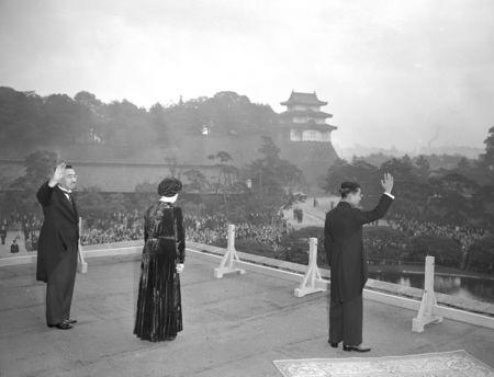 Japan's Crown Prince Akihito, flanked by Emperor Hirohito and Empress Nagako, waves to well-wishers from the balcony of the Imperial Household Agency, a day after a ceremony that Akihito is formally invested as crown prince, in Tokyo, Japan, November 11, 1952, in this photo released by Kyodo. Mandatory credit Kyodo/via REUTERS