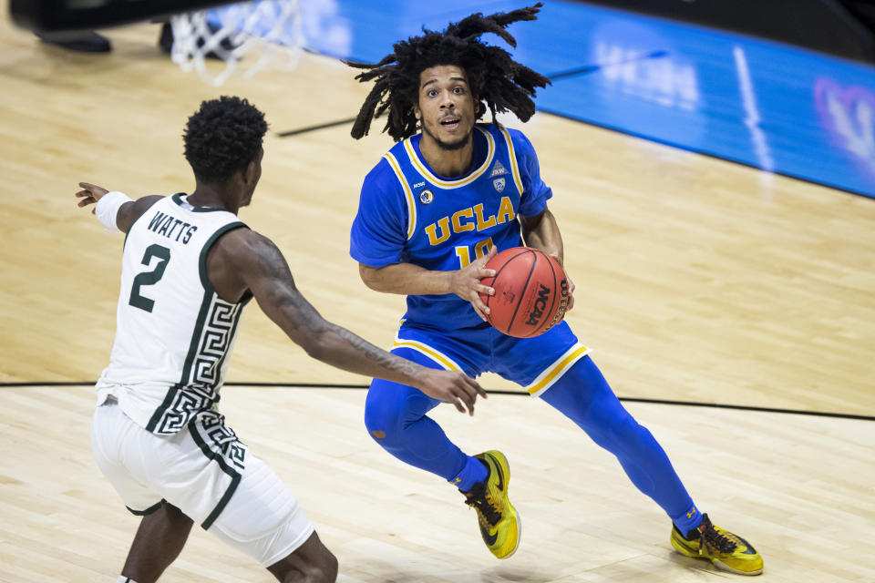 UCLA's Tyger Campbell (10) looks for a shot as Michigan State's Rocket Watts (2) defends during the second half of a First Four game in the NCAA men's college basketball tournament, early Friday, March 19, 2021, at Mackey Arena in West Lafayette, Ind. UCLA won 86-80. (AP Photo/Robert Franklin)