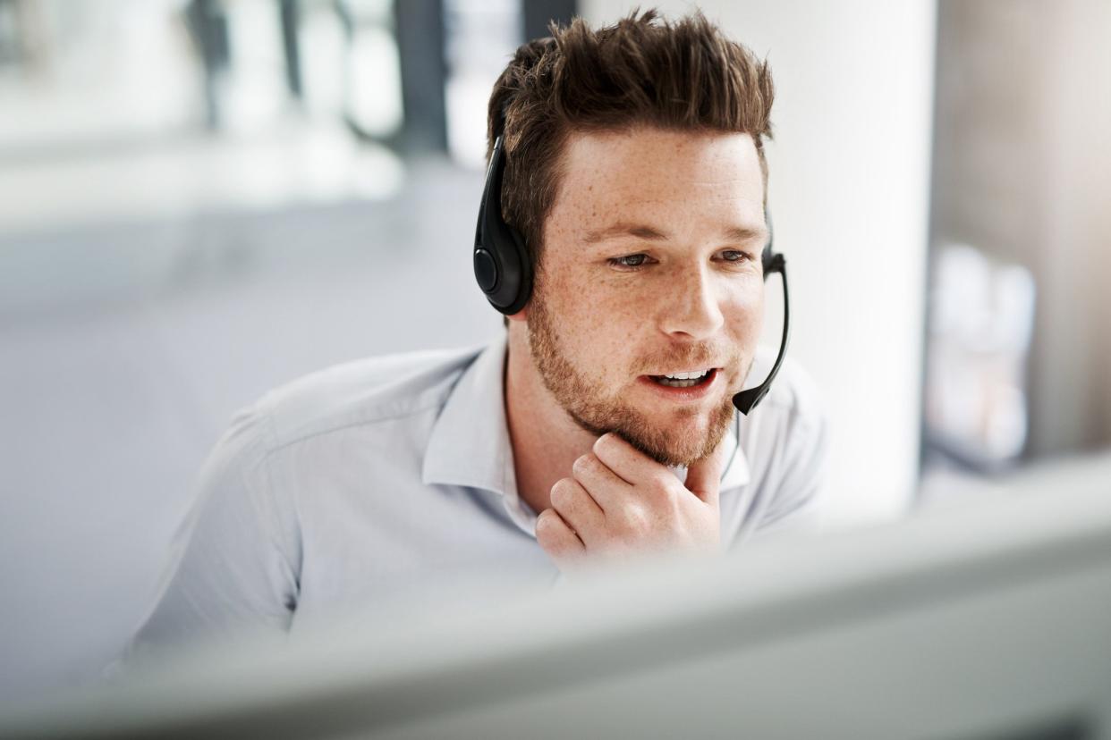 man looking  at screen wearing headset