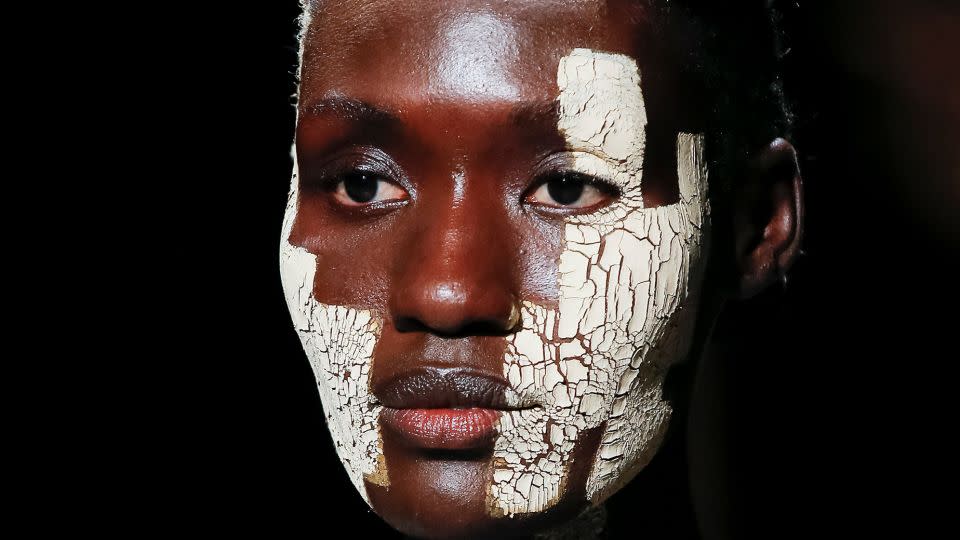 Cracking strokes of clay were brushed across models' faces at the Thom Browne show at New York Fashion Week in 2021. - Victor Virgile/Gamma-Rapho/Getty Images