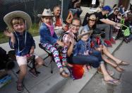 A family takes in the sights during the Calgary Stampede parade in Calgary, Friday, July 8, 2016. THE CANADIAN PRESS/Jeff McIntosh