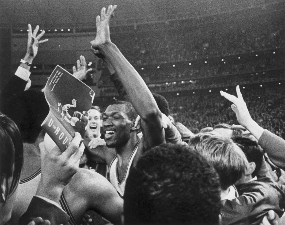 FILE - Houston's Elvin Hayes celebrates after defeating UCLA 71-69 in an NCAA college basketball game at the Astrodome in Houston, Jan. 20, 1968. Recent incidents in college basketball have underscored the potential dangers that come from jubilant fans storming the court after the game comes to an end. Finding a solution is proving to be a challenge. (Sam Pierson Jr./Houston Chronicle via AP, File)