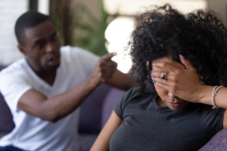 man yelling and pointing at woman, who looks tired