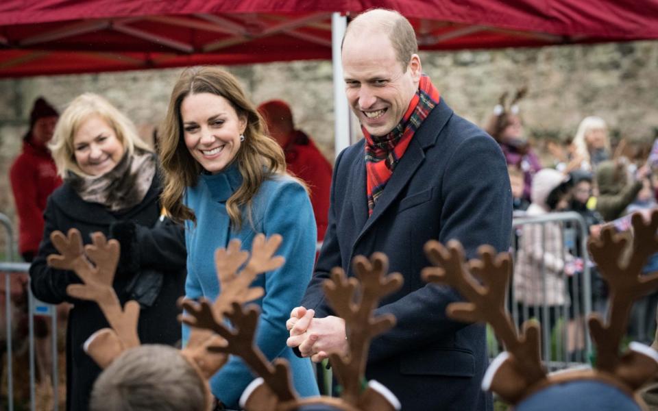The Duke and Duchess of Cambridge were greeted by students wearing santa hats and reindeer ears  - Twitter /  @KensingtonRoyal