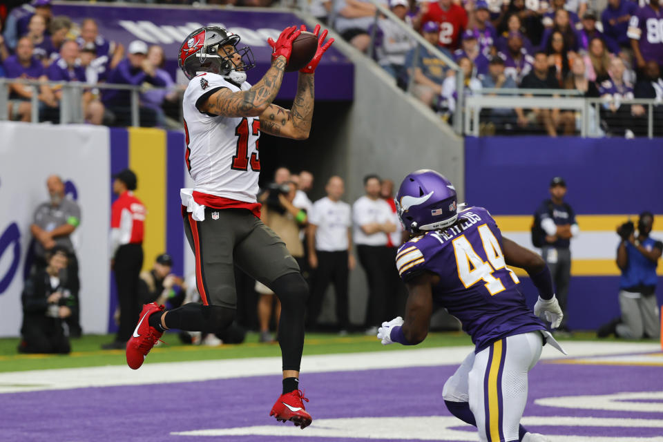 Tampa Bay Buccaneers wide receiver Mike Evans (13) catches a 28-yard touchdown pass over Minnesota Vikings safety Josh Metellus (44) during the first half of an NFL football game, Sunday, Sept. 10, 2023, in Minneapolis. (AP Photo/Bruce Kluckhohn)