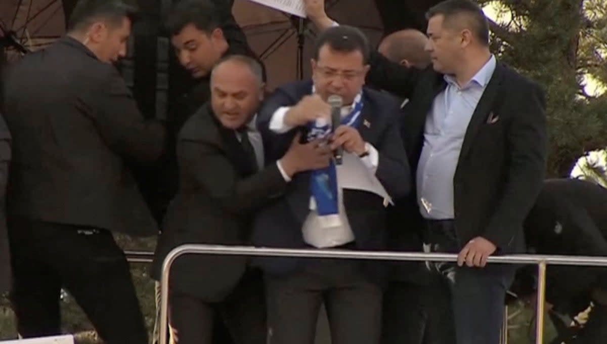 Television cameras capture the moment Istanbul mayor Ekrem Imamoglu of the CHP is pelted with stones in Erzurum, Turkey, on Sunday (via REUTERS)