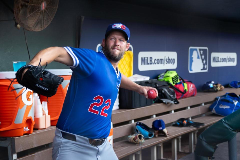 Clayton Kershaw goes through his pitching motion in the dugout before beginning rehab for triple-A Oklahoma City last Friday.