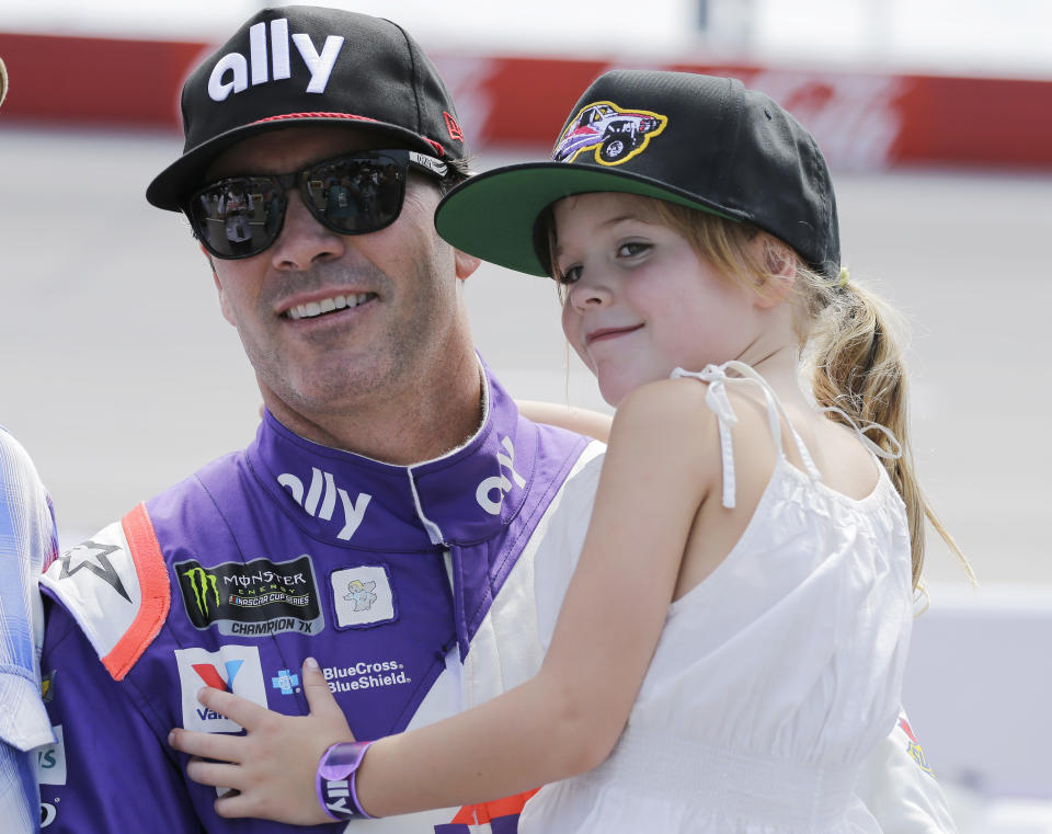 FILE - In this Aug. 31, 2019, file photo, Jimmie Johnson holds his daughter Lydia on pit road before qualifying for the NASCAR Cup series auto race at Darlington Raceway in Darlington, S.C. Seven-time NASCAR champion Jimmie Johnson says 2020 will be his final season of full-time racing. The winningest driver of his era will have a 19th season in the No. 48 Chevrolet and once again chase a record eighth championship. Johnson made the announcement in a video posted on social media, Wednesday, Nov. 20, 2019.(AP Photo/Terry Renna, File)