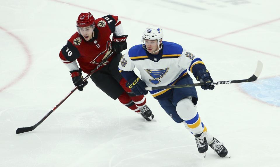 St. Louis Blues defenseman Vince Dunn (29) and Arizona Coyotes center Jordan Weal (10) skate to the puck during the third period of an NHL hockey game Thursday, Feb. 14, 2019, in Glendale, Ariz. The Blues defeated the Coyotes 4-0. (AP Photo/Ross D. Franklin)