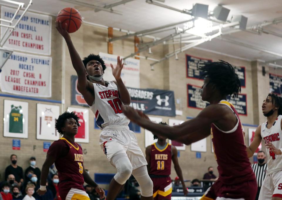 Stepinac's Isaiah Alexander (10) goes up for a shot against Hayes during boys basketball action at Archbishop Stepinac High School in White Plains Jan. 28, 2022. Stepinac won the game 67-56.