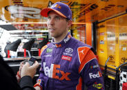 Denny Hamlin is interviewed after practice for the NASCAR Cup Series auto race at the Homestead-Miami Speedway, Saturday, Nov. 17, 2018, in Homestead, Fla. Hamlin won the pole position. (AP Photo/Terry Renna)