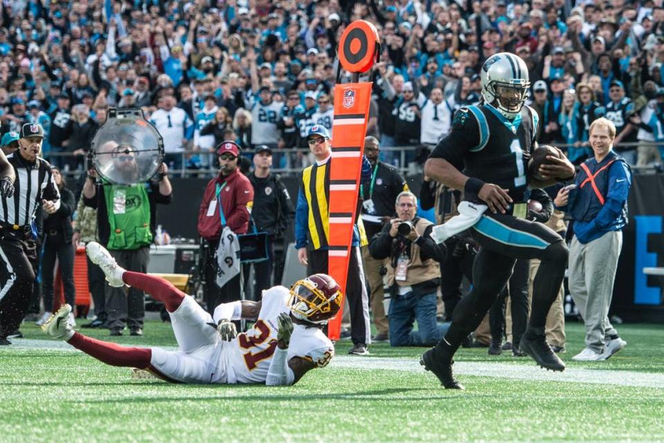 Carolina Panthers Cam Newton, right, makes a touchdown against Washington Football Team at the Bank of America Stadium in Charlotte, N.C., on Sunday, November 21, 2021.