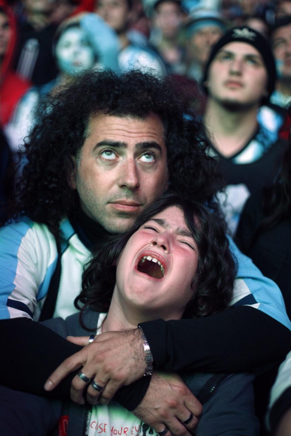 Argentina's fans react after Argentina loss to Germany in their 2014 World Cup final soccer match in Brazil, at a public square viewing area in Buenos Aires