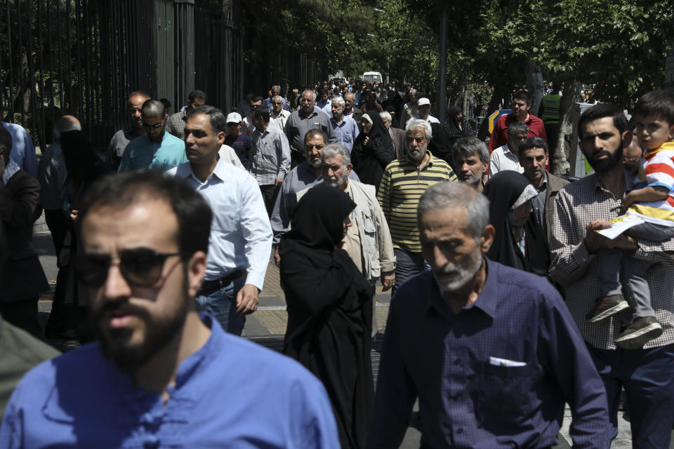 In this Friday, May 17, 2019 photo, worshippers leave at the conclusion of Friday prayers in downtown Tehran, Iran. (AP Photo/Vahid Salemi)