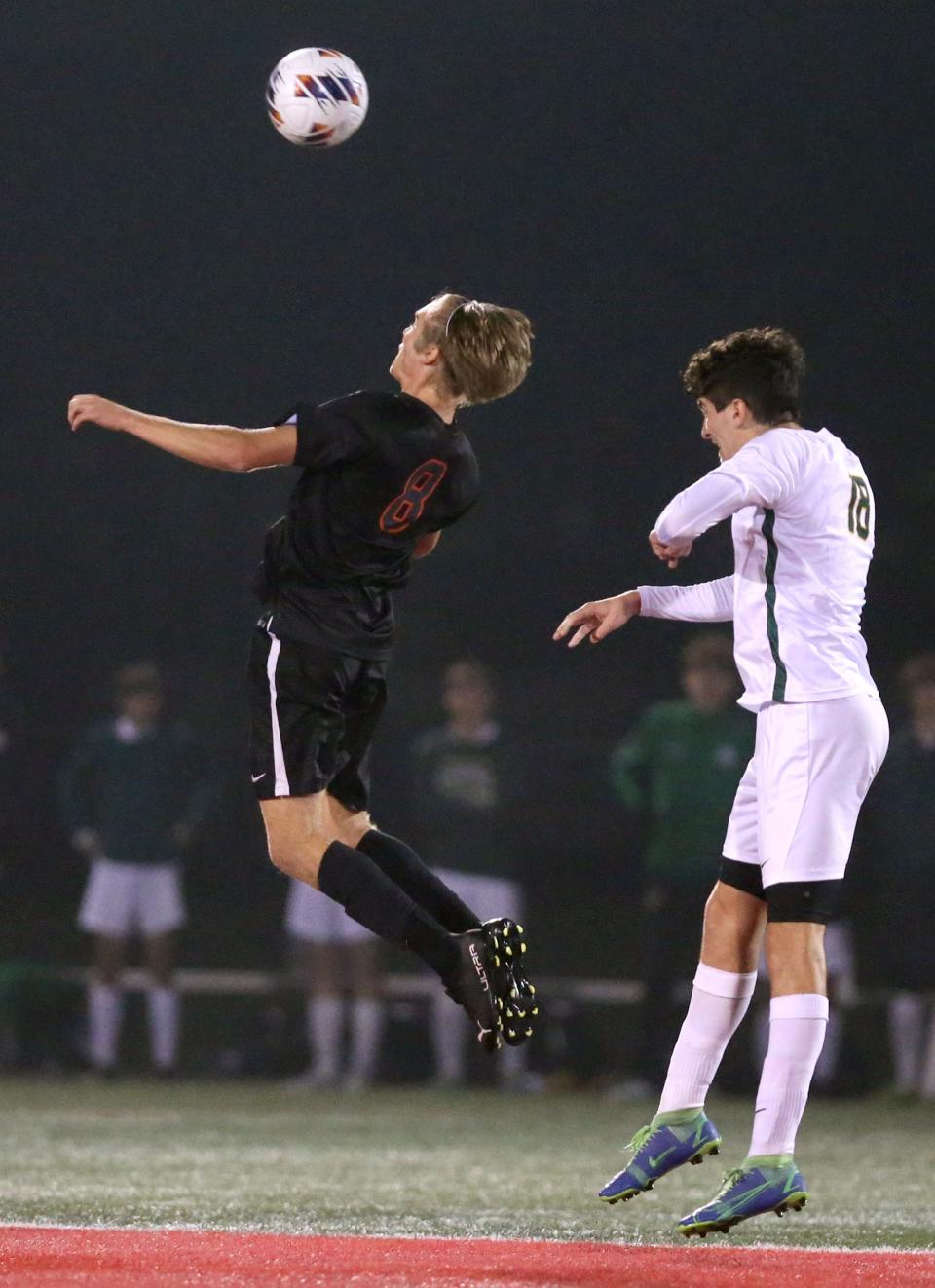 Hoover's Cam VanNatta (left) goes for a header with Medina's Landon Daum during a Division I regional semifinal game earlier this month.