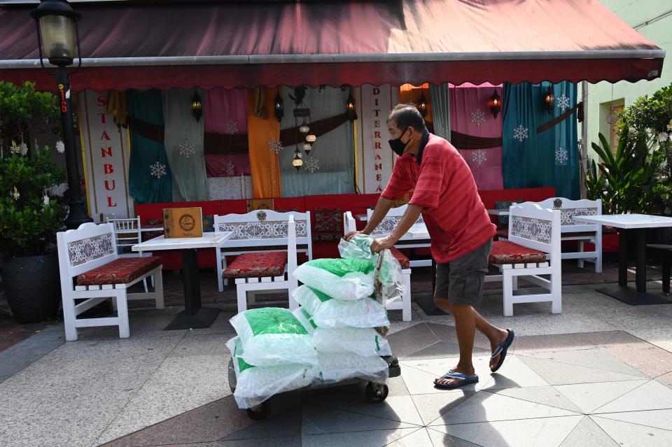 A man pushes a trolley load of ice to a restaurant in the Arab Street district. (PHOTO: Getty Images)