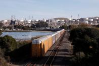 A train runs along the tracks towards the Phillips 66 refinery in Rodeo, CA