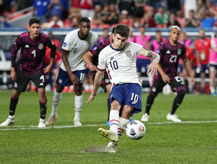 FILE - In this June 6, 2021, file photo, United States' Christian Pulisic (10) kicks a penalty kick for a goal against Mexico during extra time in the CONCACAF Nations League championship soccer match in Denver. Pulisic's availability for the United States' opening World Cup qualifier remains unclear following his positive COVID test. The top American player was on the 26-man roster announced Thursday for the first three qualifiers after missing Chelsea's match at Arsenal last weekend. The U.S. starts at El Salvador on Sept. 2. (AP Photo/Jack Dempsey, File)