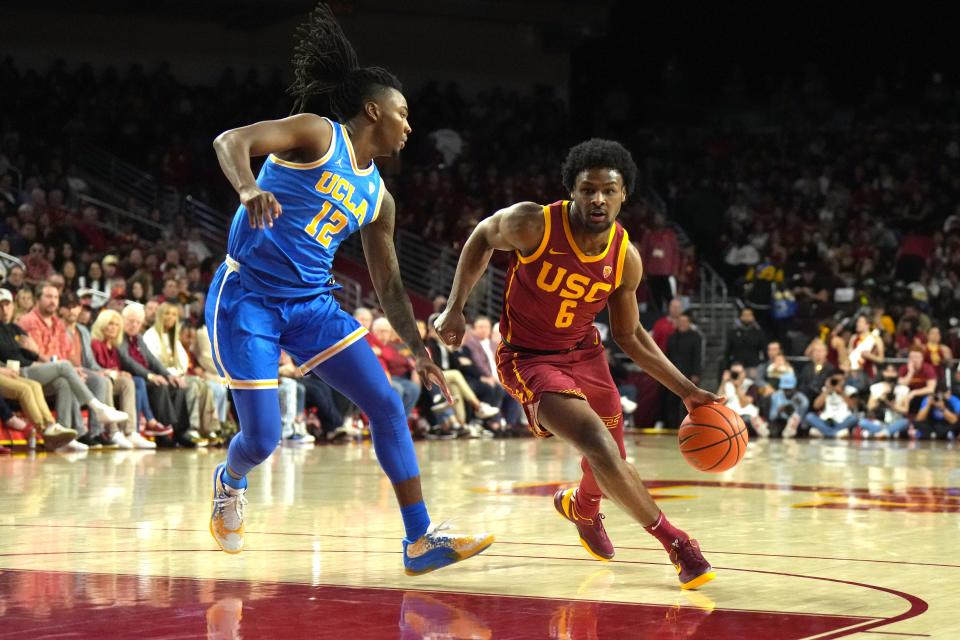 Southern California Trojans guard Bronny James (6) dribbles the ball against UCLA Bruins guard Sebastian Mack (12) in the second half at Galen Center. The Trojans and Bruins have been two of the most underwhelming teams in the 2023-24 season.